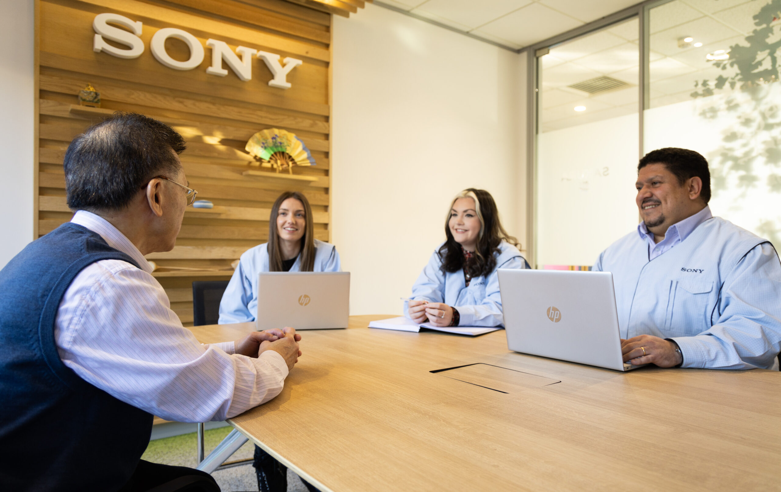 a photo of 4 people having a meeting