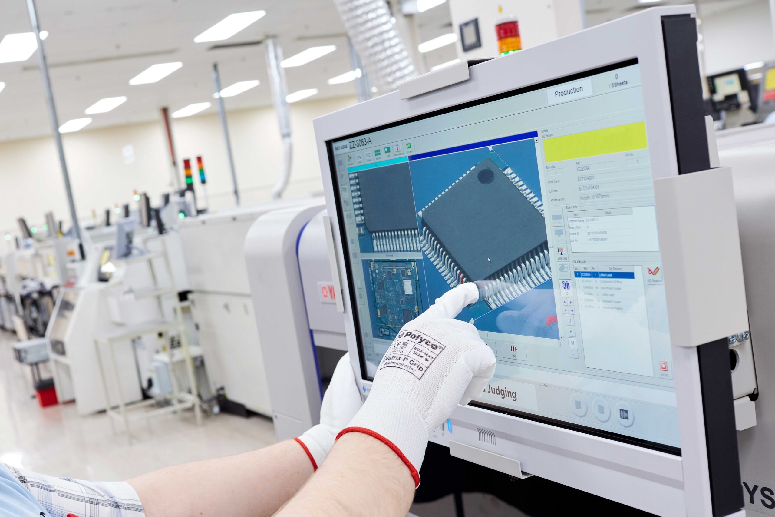 A screen showing a process which is used to find quality issues. A hand is touching the screen to interact with the 3D image of a circuit board component on the display.